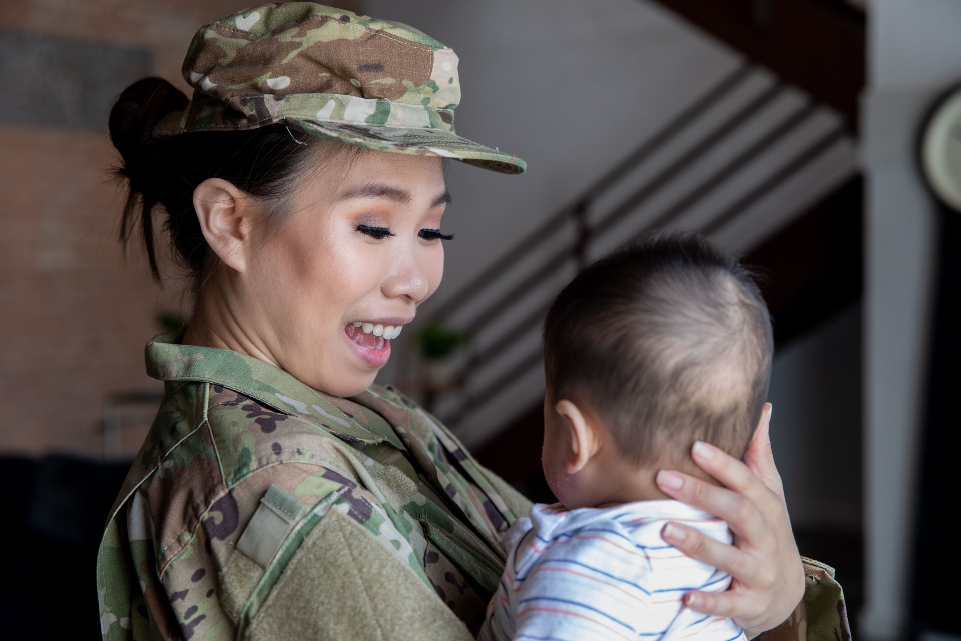 Young female soldier has bonding moment with newborn son before reporting for military duty